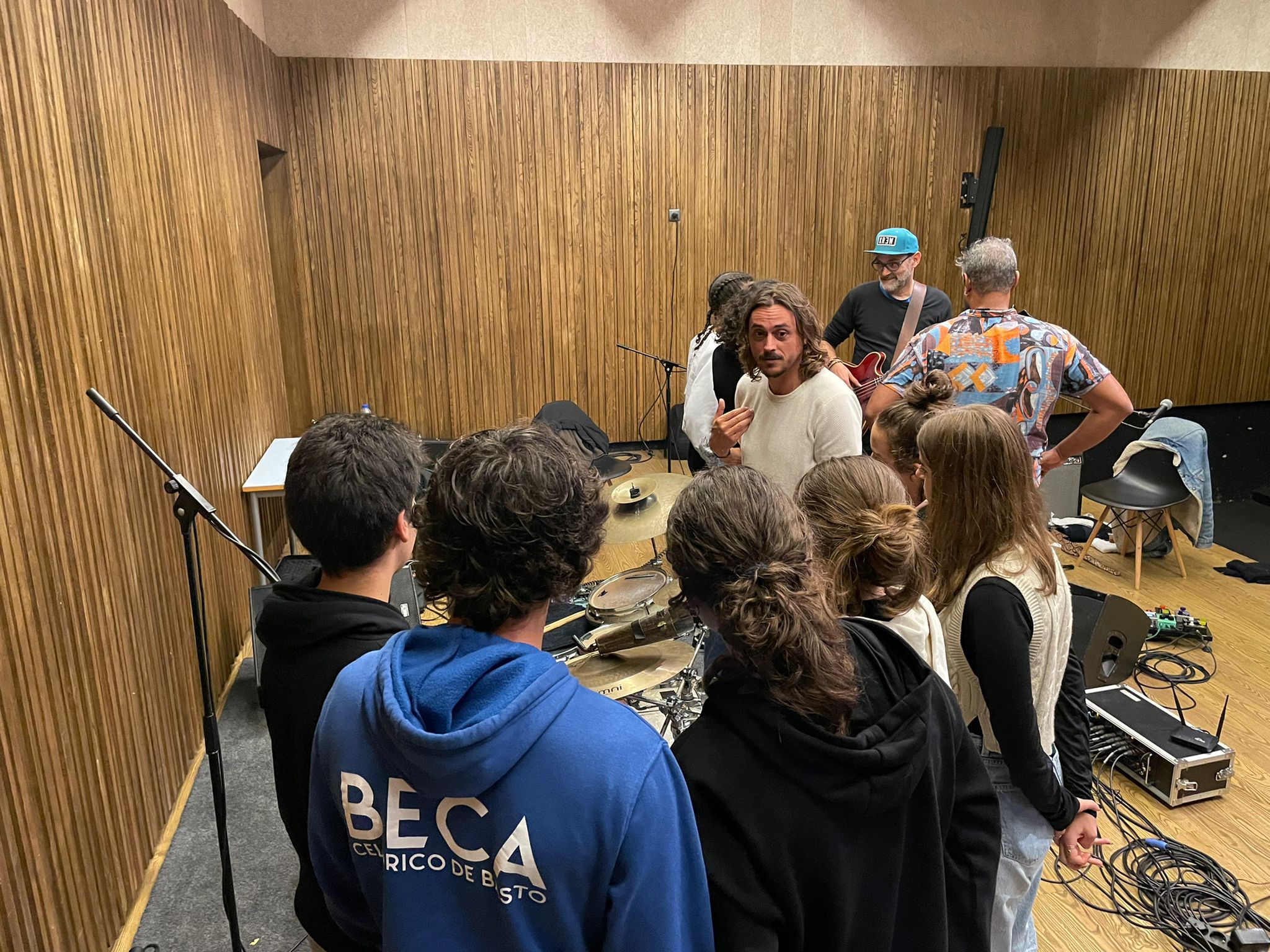 Elementos dos Fogo Fogo em interação com os jovens músicos locais, numa atividade da residência artística.
